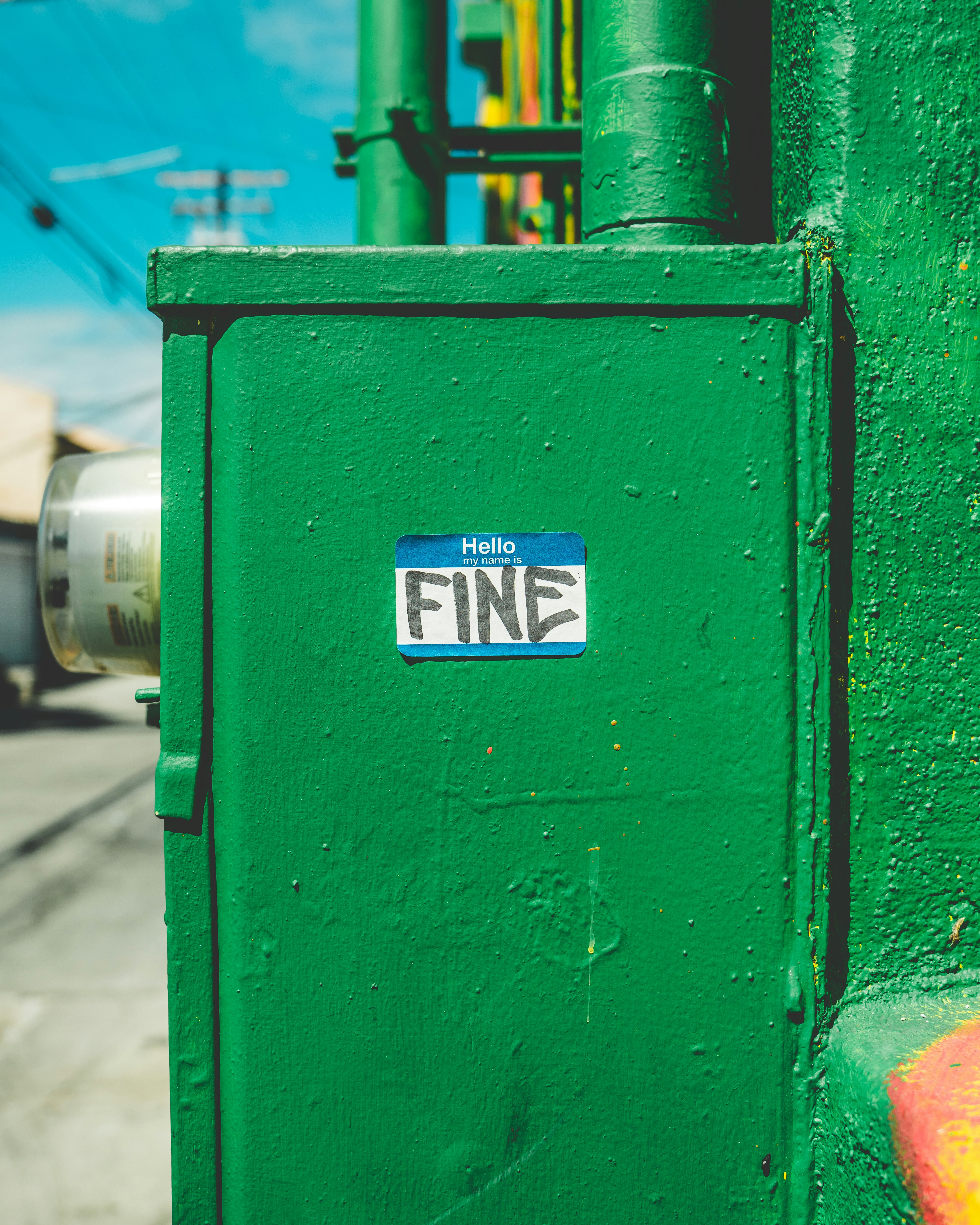 green steel box with fine-printed sticker